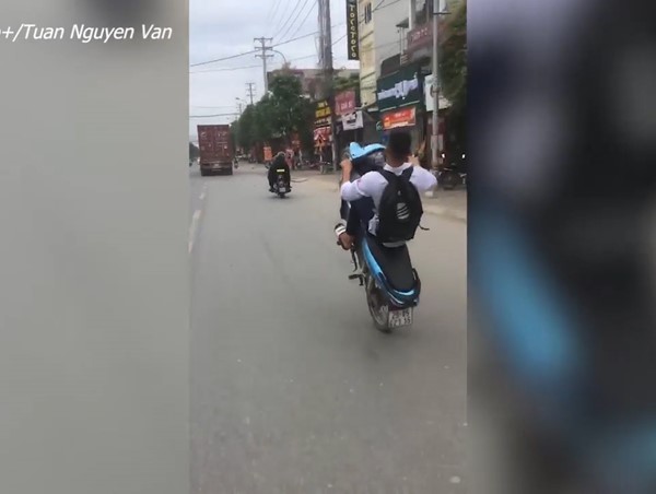 Nam sinh mặc đồng phục bốc đầu xe máy