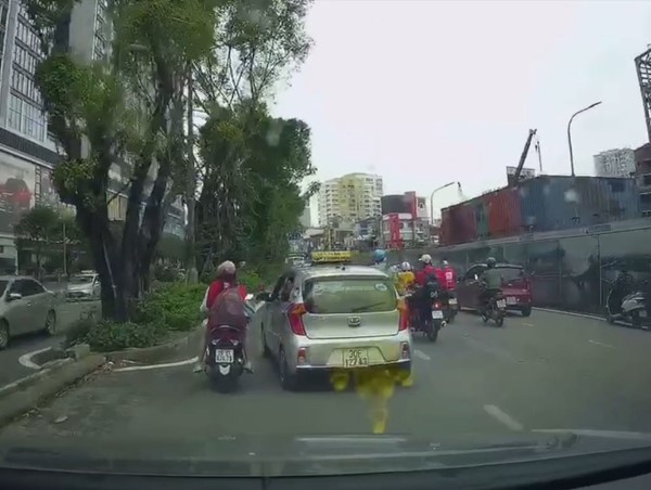 Clip: Taxi ép hai mẹ con cô gái đi xe máy vào dải phân cách