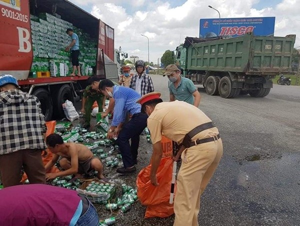 Hà Tĩnh: Công an và người dân giúp tài xế thu gom hàng trăm két bia rơi trên đường