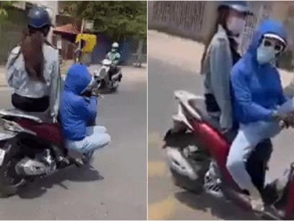 Cô gái "làm xiếc" trên xe máy