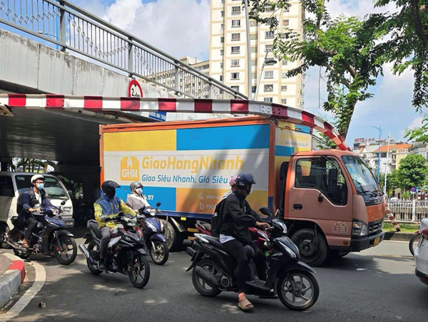 Xe tải tông sập thanh chắn giới hạn chiều cao, mắc kẹt dưới gầm cầu