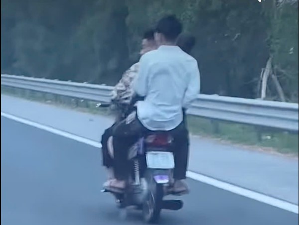 Thanh niên kẹp ba đi xe máy trên cao tốc