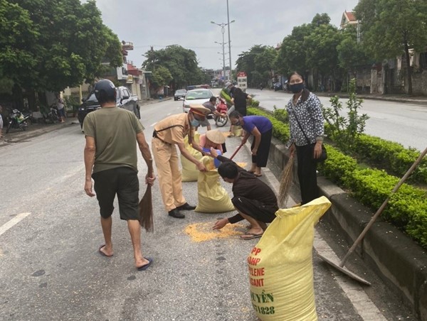Hình ảnh đẹp của CSGT Quảng Ninh khi giúp người dân thu gom những hạt ngô vương vãi