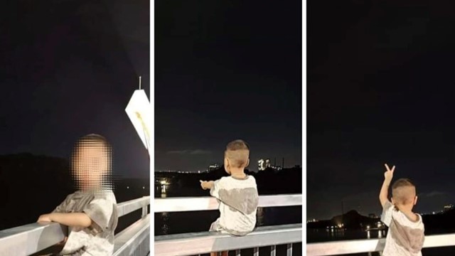 Bé trai ngồi trên lan can cầu Bến Rừng vừa thông xe