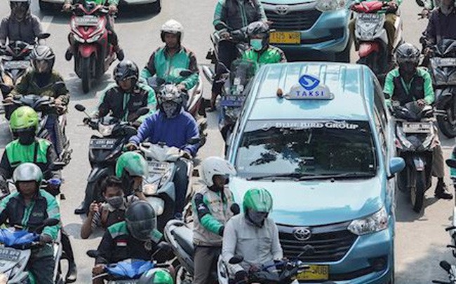 Grab, Go-Jek lo so hieu ung domino tu luat Uber tai My - Hinh anh 1